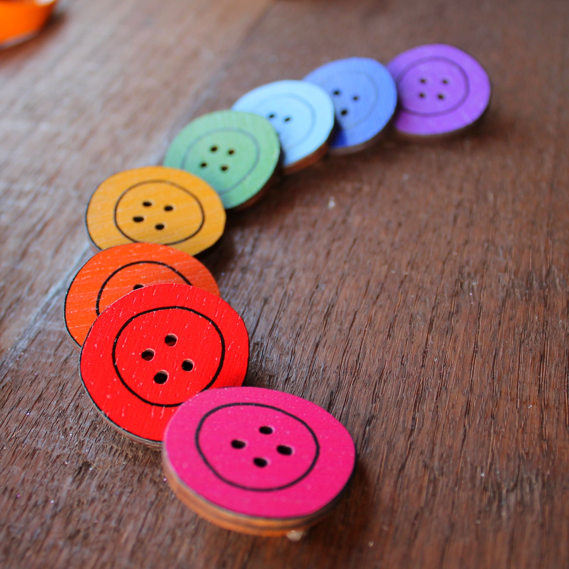 wooden button brooch in a rainbow of colours by Laura Lee Designs in Cornwall