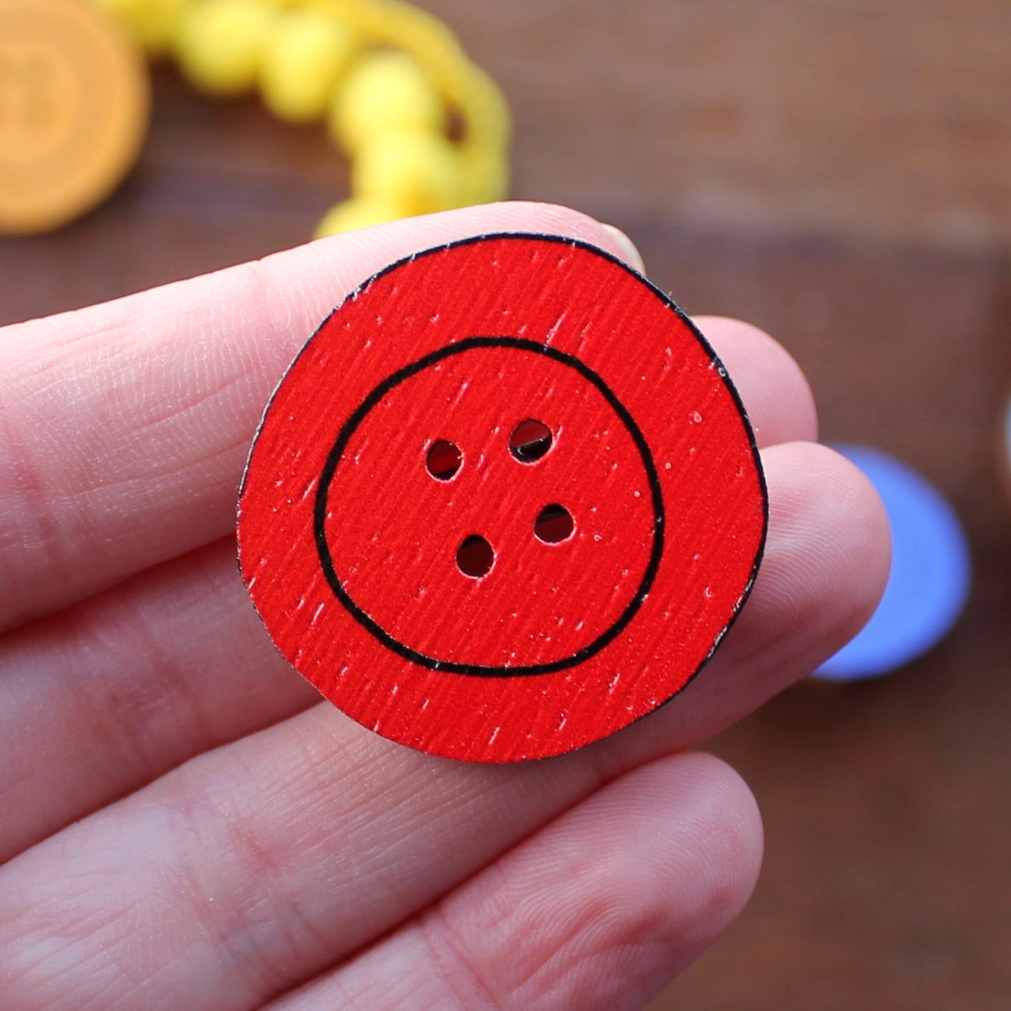 Red wooden button brooch by Laura Lee Designs in Cornwall